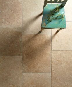 Noce Travertine tiles with a green chair.