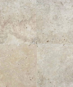 An up close shot of a travertine tile with natural holes.