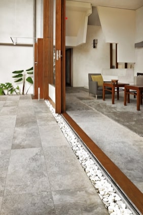 Silver travertine pavers laid in an outdoor/indoor setting.