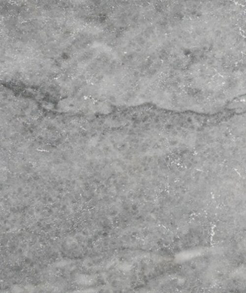 The surface of a grey limestone tile.