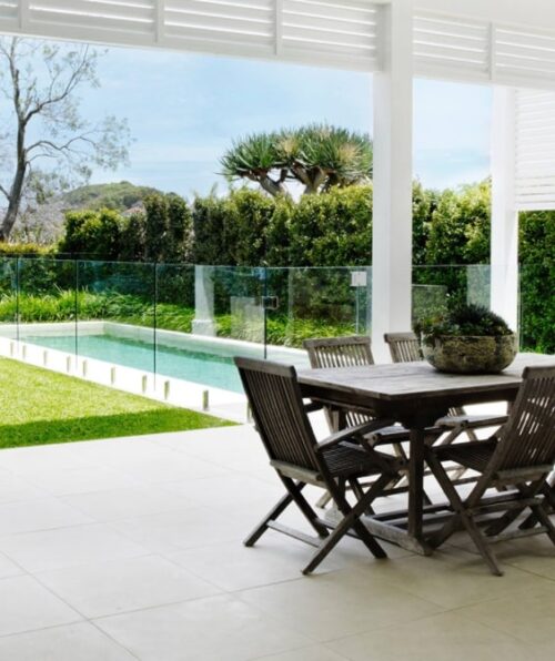 White outdoor pavers with a black outdoor table set.